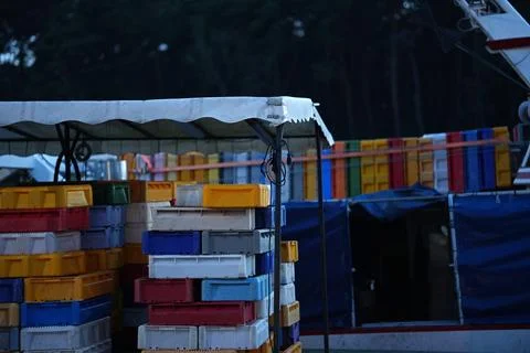 Loading of many plastic containers on a ship in the seaport. Stock Photos