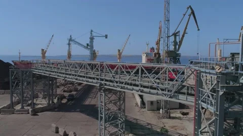 Loading of a merchant ship in port with grain using a belt gallery Stock Footage 147732233