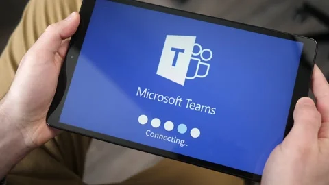 Loading Microsoft Teams app on a Tablet Screen to Video Chat Stock Footage 146998959