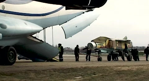Loading of MiG-23 fighter into cargo compartment of Il-76 transport aircraft. Stock Footage 142008720