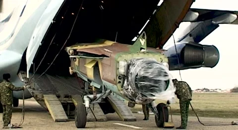 Loading of MiG-23 fighter into cargo compartment of Il-76 transport aircraft. Stock Footage 144254576