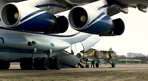 Loading of MiG-23 fighter into cargo compartment of Il-76 transport aircraft. Stock Footage 144254589