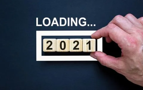 Loading new year 2021 with hand putting wood cube in progress bar. Business c Stock Photos