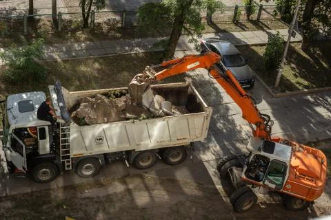 Loading of old concrete structures into dump truck with an excavator. Stock Photos