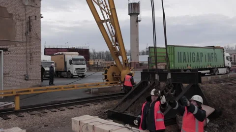 Loading operations with rail crane and few workers in the dock Stock Footage 62084463
