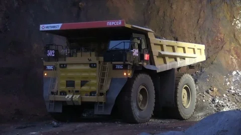 Loading the ore into heavy dump truck at the opencast mining site Stock Footage 83252212
