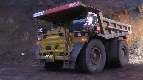 Loading the ore into heavy dump truck at the opencast mining site Stock Footage 83252238