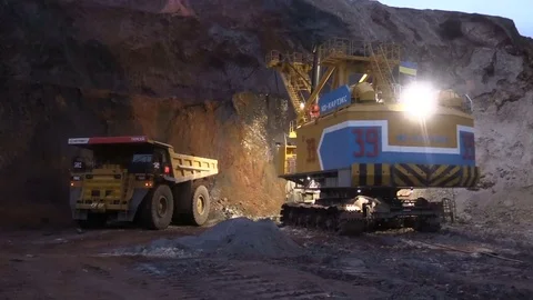 Loading the ore into heavy dump truck at the opencast mining site Stock Footage 83252428
