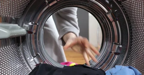 Loading out the laundry from the washing machine. View Looking Out From Insid Stock-Footage 152856039