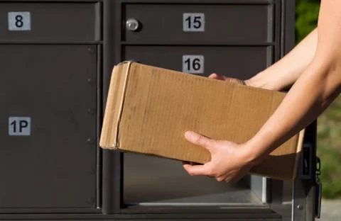 Loading package into mailbox Stock Photos