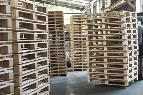 Loading pallets with forklift in stacks for storage or transportation Stock Photos