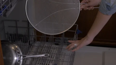 Loading Pan Mesh Cover Into Dishwasher Stock-Footage 96429003
