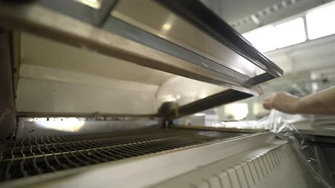 Loading paper blanks into machine for packing in film Vídeos de archivo 296577072