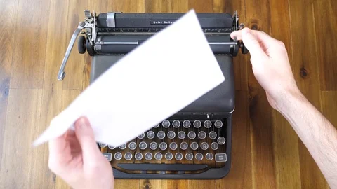 Loading paper in an old Typewriter and typing Stock Footage 116531815