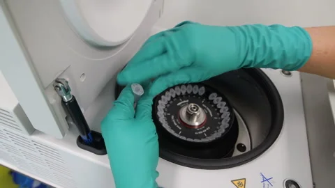 Loading a Pharmaceutical Centrifuge Apparatus Stock Footage 290298662