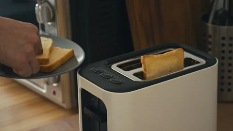 Loading Pieces of White Bread into Toaster While Preparing Breakfast Stock Footage 259291413