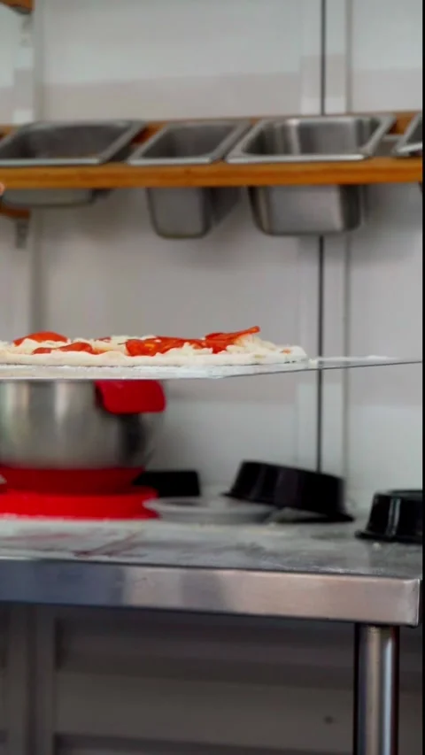 Loading a pizza into the oven Stock Footage 298724711