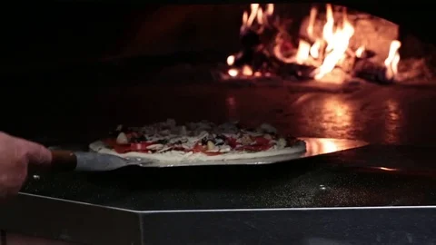 Loading Pizza Into Wood Fired Oven With Peel Stock Footage 73900638