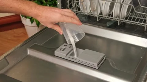 Loading the powder into dishwasher. A man pours powder in the dishwasher to wash Stock Footage 246641523