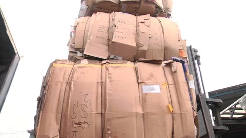 Loading of the pressed cardboard on the truck for sending for recycling Stock Footage 104645404
