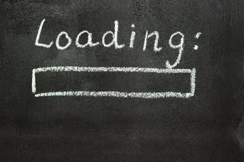 The loading process is shown in white on a chalkboard. Stop motion animation Stock Photos