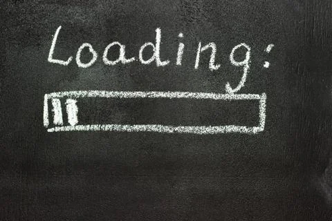 The loading process is shown in white on a chalkboard. Stop motion animation Stock Photos