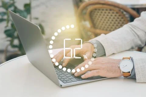 Loading progress. Man working on laptop at table indoors, closeup Stockfoto's
