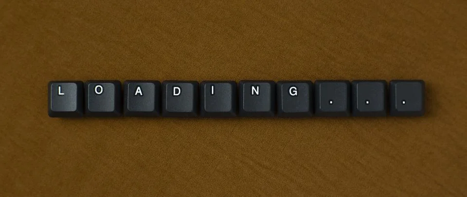Loading Progress Message With Keyboard Keys On Brown Background Stock Photos