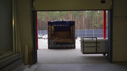 Loading PVC profile for windowsills in truck trailer at storege Stock Footage 304393316