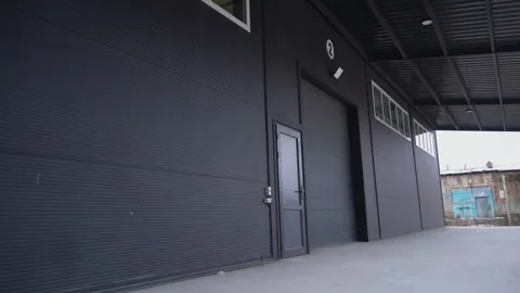Loading ramp of modern industrial facility with black facade Video stock 304394349