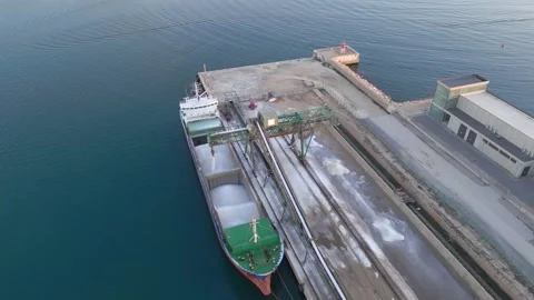 Loading salt into a cargo ship for transportation by sea Stock Footage 228365173