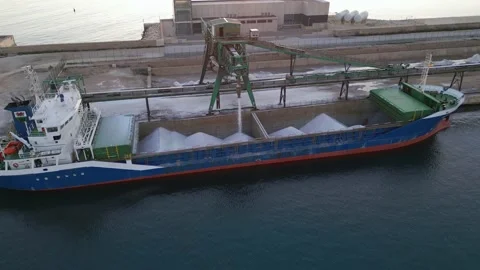 Loading salt into a cargo ship for transportation by sea. Stock Footage 228365309