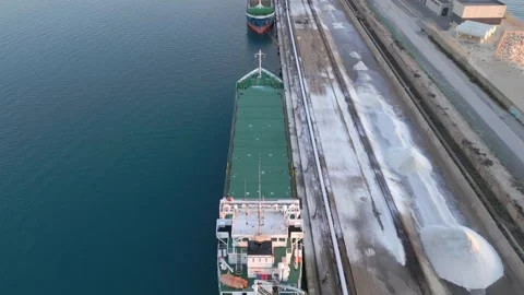 Loading salt into a cargo ship for transportation by sea. Stock Footage 228366178