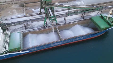 Loading salt into a cargo ship for transportation by sea. Stock Footage 228367347