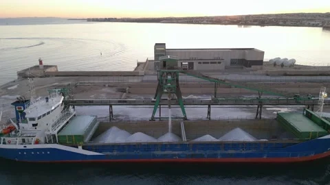 Loading salt into a cargo ship for transportation by sea. Stock Footage 228367393