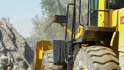 Loading shovel working to clear rubble from streets of Raqqah, Syria Stock Footage 94565349