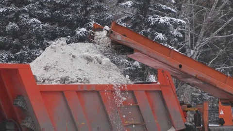 Loading snow to truck. Сlearing streets of snow using machines Stock Footage 70788693