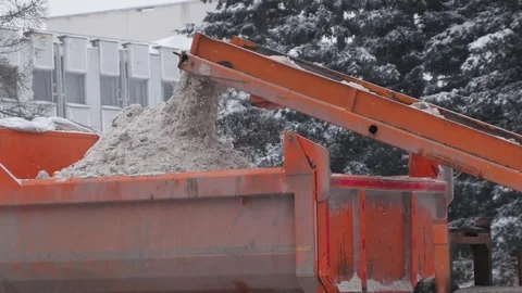 Loading snow to truck. Сlearing streets of snow using machines. Close. Stock-Footage 70788924
