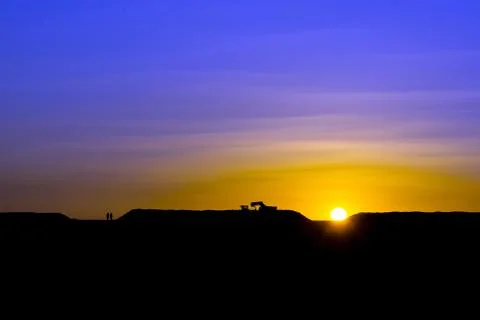 Loading sugar beets into trucks in the sun at sunset Stock Photos