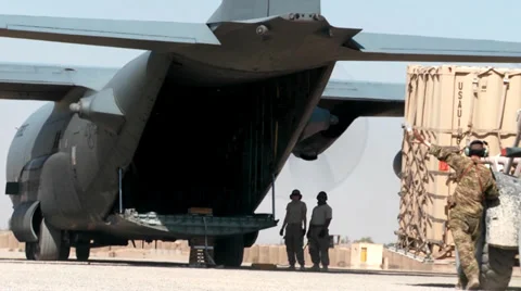 Loading supplies and cargo into a C-130 Hercules transport plane Stock Footage 32661029