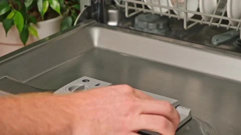 Loading the tablet into the dishwasher. A man puts tablet in the dishwasher to Stock Footage 244803656
