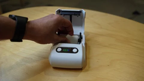 Loading Thermal Paper Roll into Portable Mini Printer – Office or POS Setup Video stock 317073879