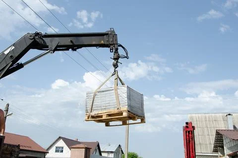 Loading tiles to the ground from a car. Delivery and unloading of building ma Stock Photos