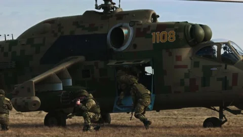 Loading troops into the transport cabin of an attack helicopter. Multi-purpose Video stock 172653458