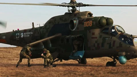 Loading troops into the transport cabin of an attack helicopter. Multi-purpose Video stock 172655332