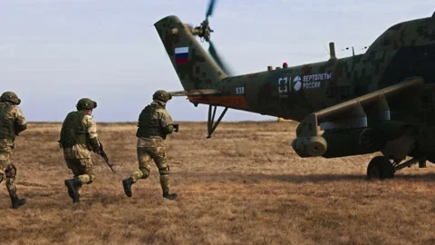 Loading troops into the transport cabin of an attack helicopter. Multi-purpose Video stock 172655407