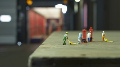 Loading a truck with miniature models in foreground Stock Footage 102554930