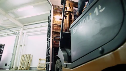 Loading of a truck. a worker on a small auto-loader, Electric forklift truck Stock Footage