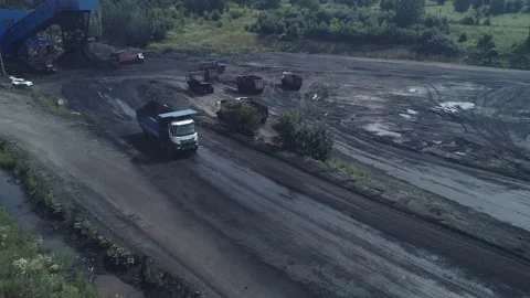 Loading trucks with coal ore. The drone flies over a heavy dump truck loaded to Stock Footage 169590277