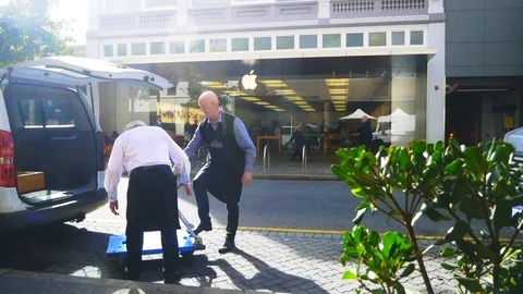 Loading a van outside an Apple retails store in the city Stock Footage 93037119